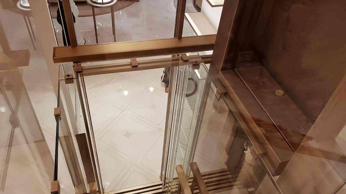 High-end glass elevator with ocean view in Newport Beach, luxury glass elevator design by Roys Rise Corp.