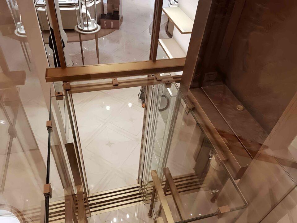 High-end glass elevator with ocean view in Newport Beach, luxury glass elevator design by Roys Rise Corp.