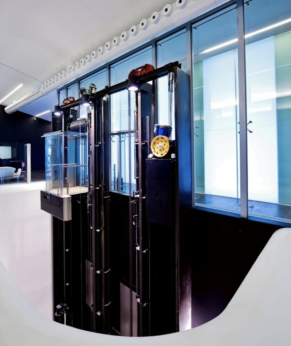 Custom Commercial Elevators - Modern glass elevator designed for a corporate building by Roys Rise