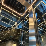 Custom home glass elevator with metal framing and warm LED lighting, featured in Roys Rise’s Utah elevator article.