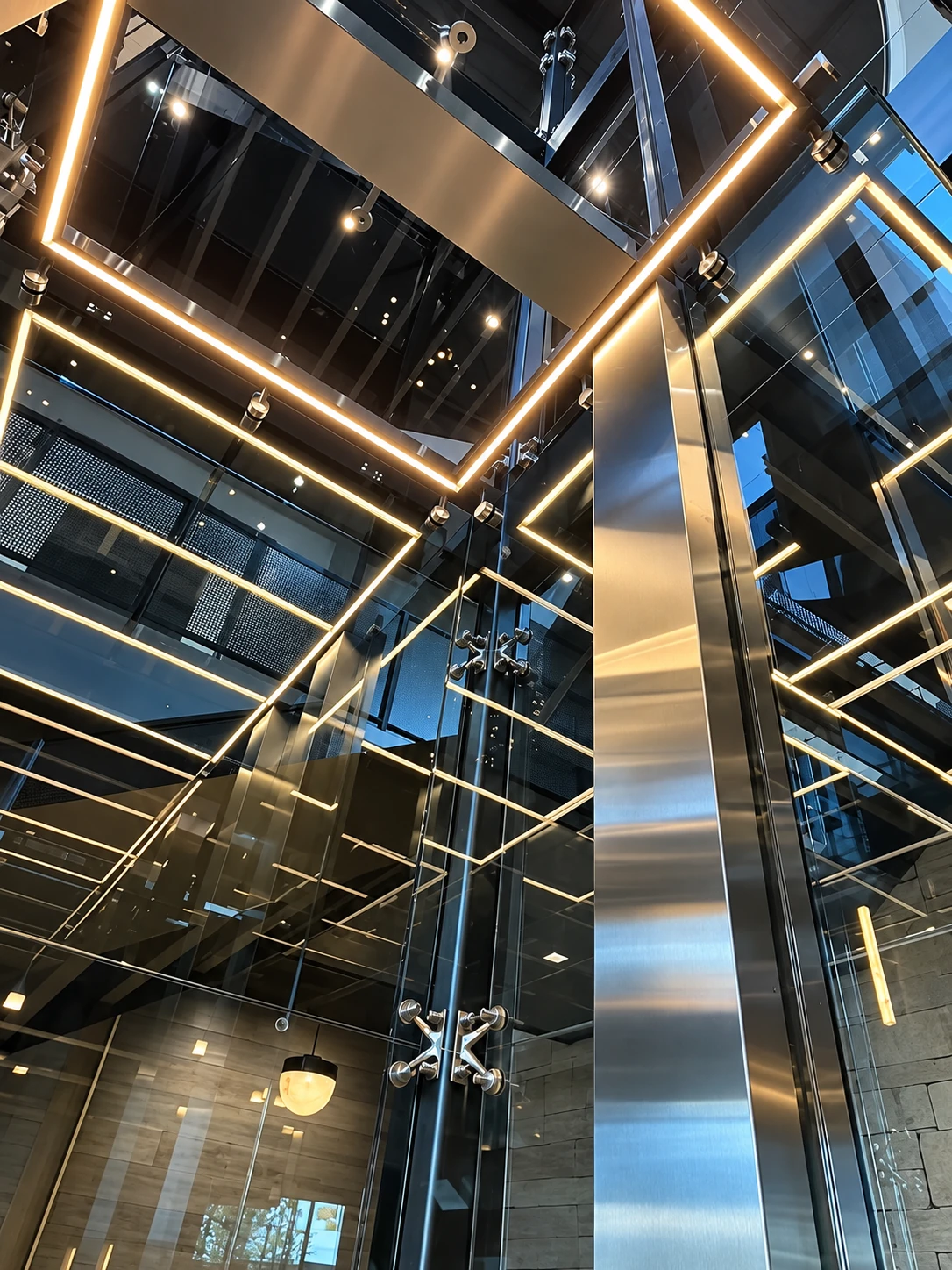 Custom home glass elevator with metal framing and warm LED lighting, featured in Roys Rise’s Utah elevator article.